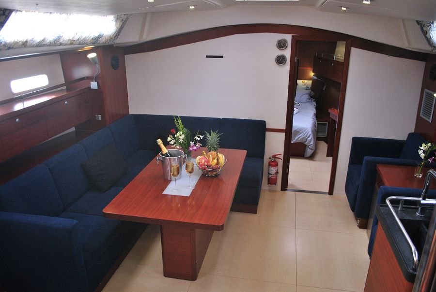 Furnished living room with equipped kitchen on the sailboat.